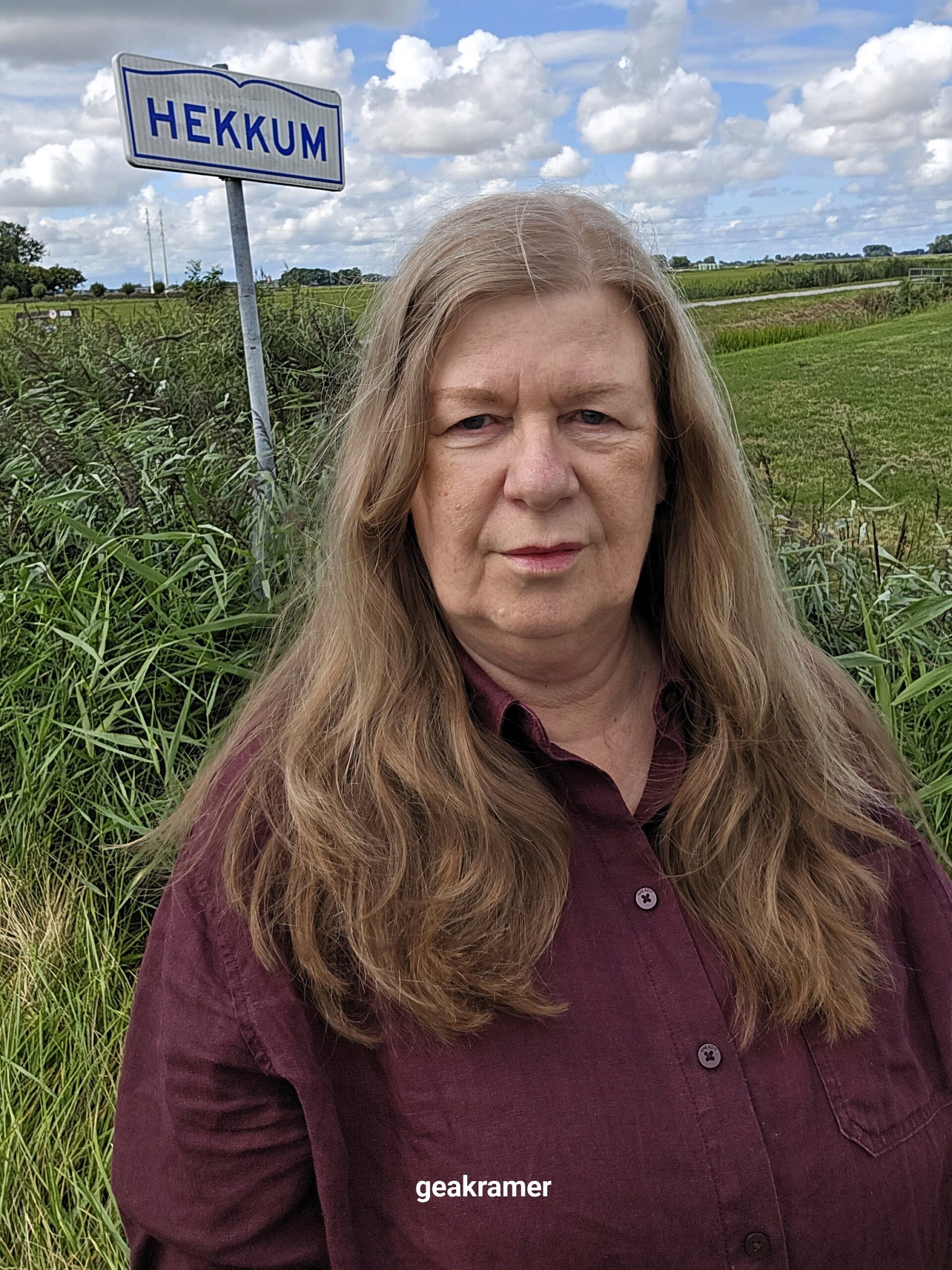 Gea Kramer bij het plaatsnaambord Hekkum in het Reitdiepgebied, Groningen